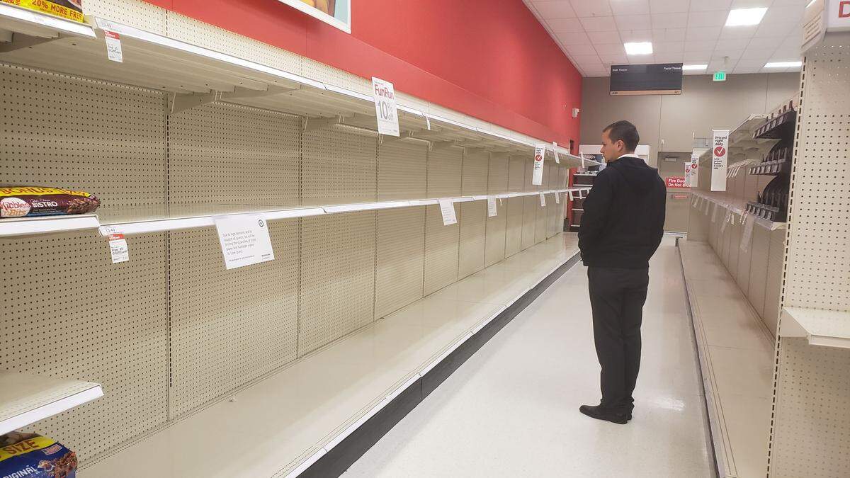 A Target customer read the sign asking that people take only one package of toilet paper, however none were left.