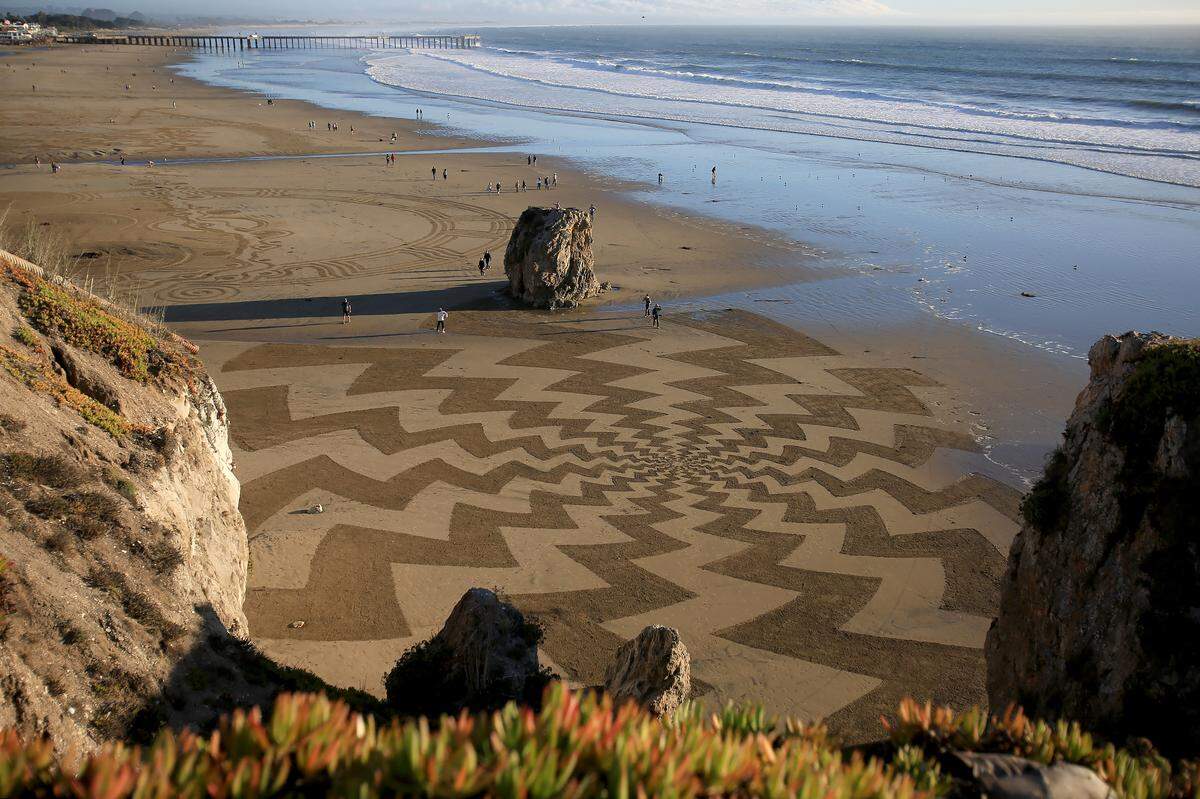 The Pismo Beach Sand Art Festival runs Nov. 6 to Nov. 8 as artists carve sand murals at low tide; view zones from SeaCrest, Wilmar Avenue, the pier or hotel rooftops. This sand art was created by Andreas Hoenigschmid based in Southern California.
