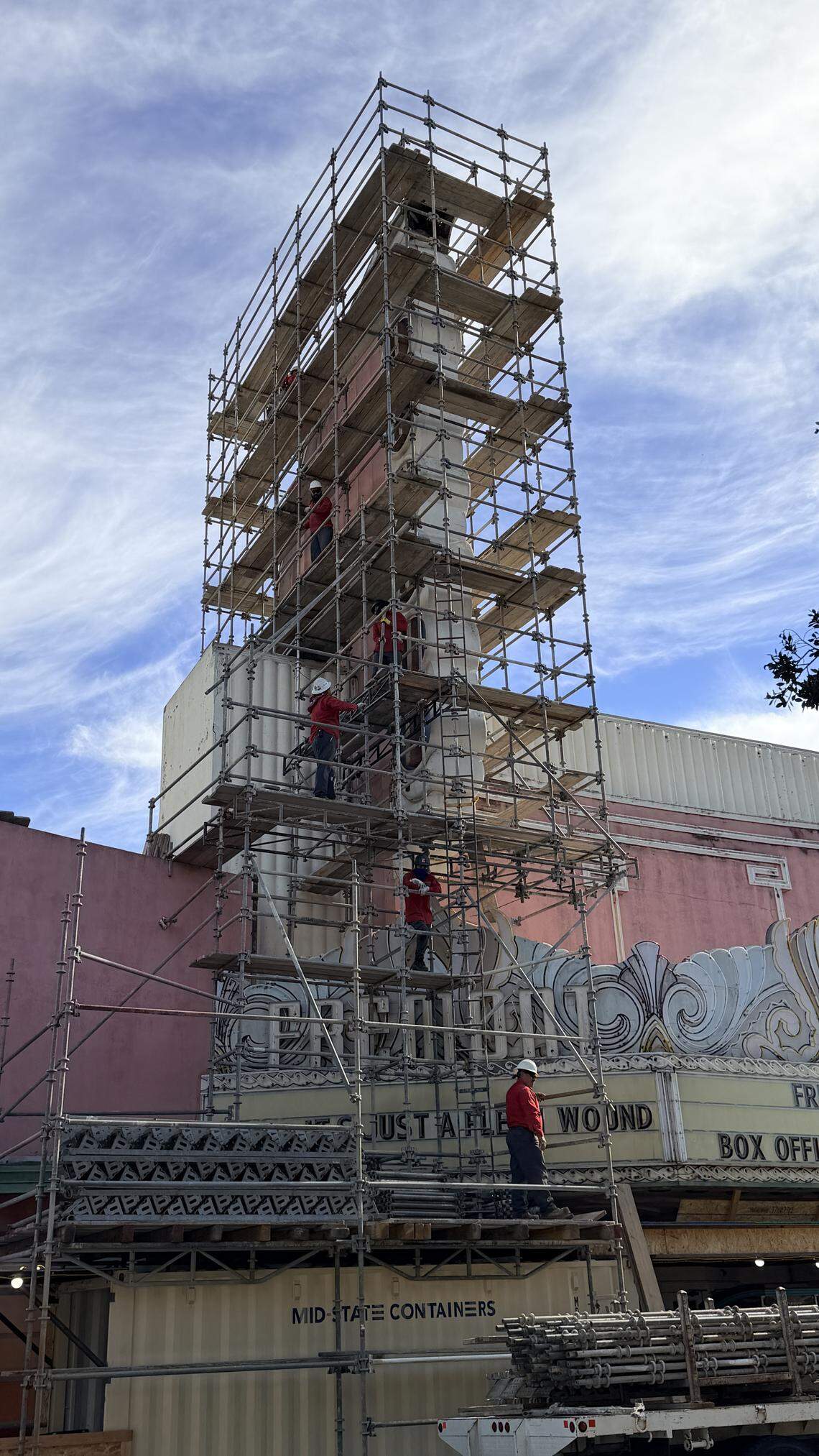 Workers set up scaffolding around the damaged Fremont Theater sign on Wednesday Feb. 25, 2026, in downtown San Luis Obispo.