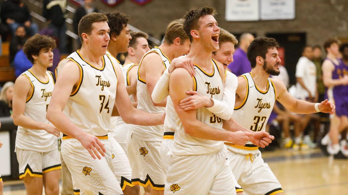 San Luis Obispo celebrates their win as the clock runs out. The San Luis Obispo HIgh School boys basketball team plays host to Lemoore in a semifinal game of the CIF-Central Section playoffs.