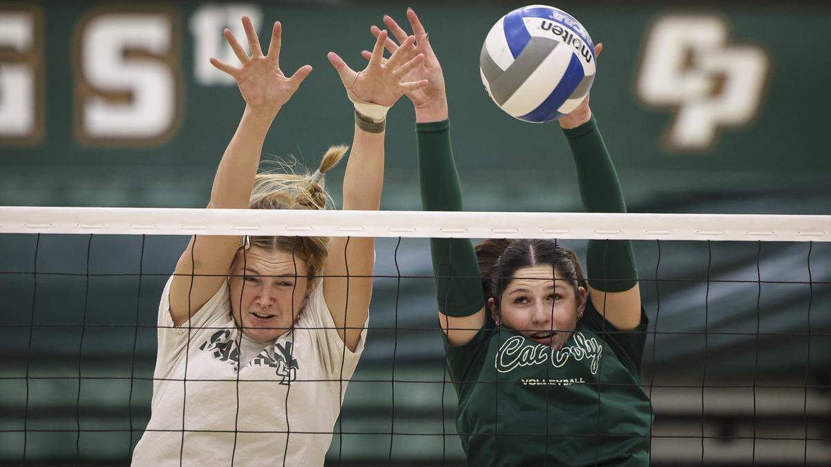 Chloe Leluge, left, and Emma Fredrick block at the net during Cal Poly women's volleyball practice on Dec. 8, 2025. The Mustangs advanced to the Sweet 16 in the NCAA Women’s Volleyball Championship tournament, the first time they’ve reached that stage in 18 years.