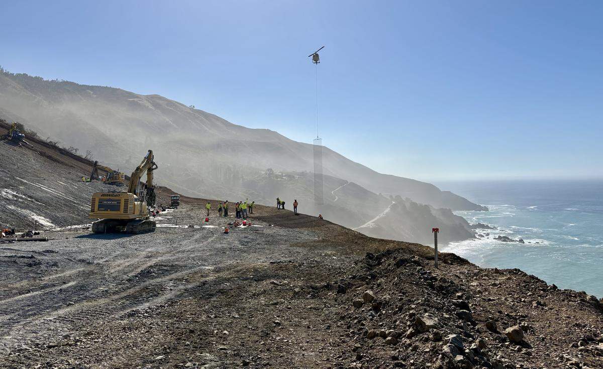 Workers lay cable-net drapery over a hillside at the the site of the Regent’s Slide along the Big Sur Coast in October 2025.