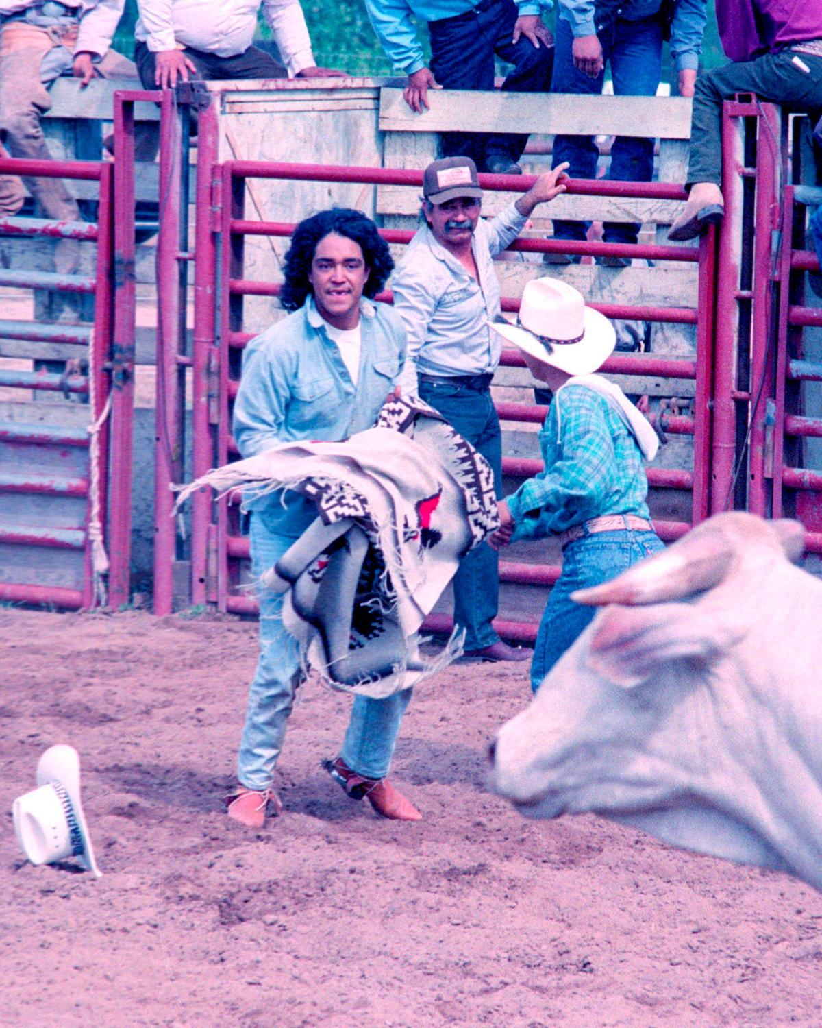After being thrown, Javier Ceja takes a serape and persuades a bull to leave the arena through the exit chute. A charreada, or Mexican rodeo, was held at Nipomo Regional Park on May 30, 1993.