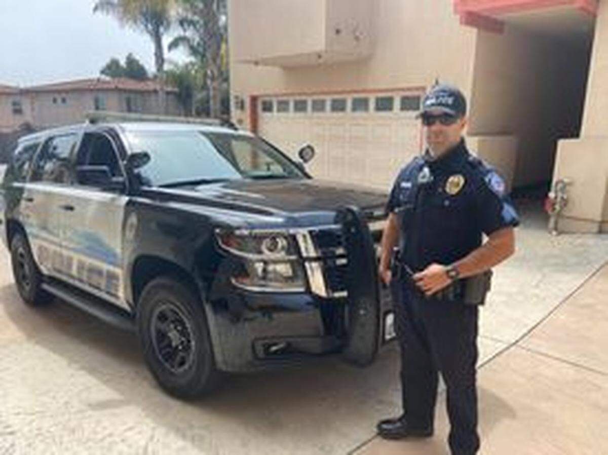 Former Pismo Beach Police Department Sergeant Adrian Souza stands outside his patrol vehicle at an apartment in Pismo Beach. According to to an investigation by the agency’s Internal Affairs Division, he engaged in oral sex with a woman while on duty.