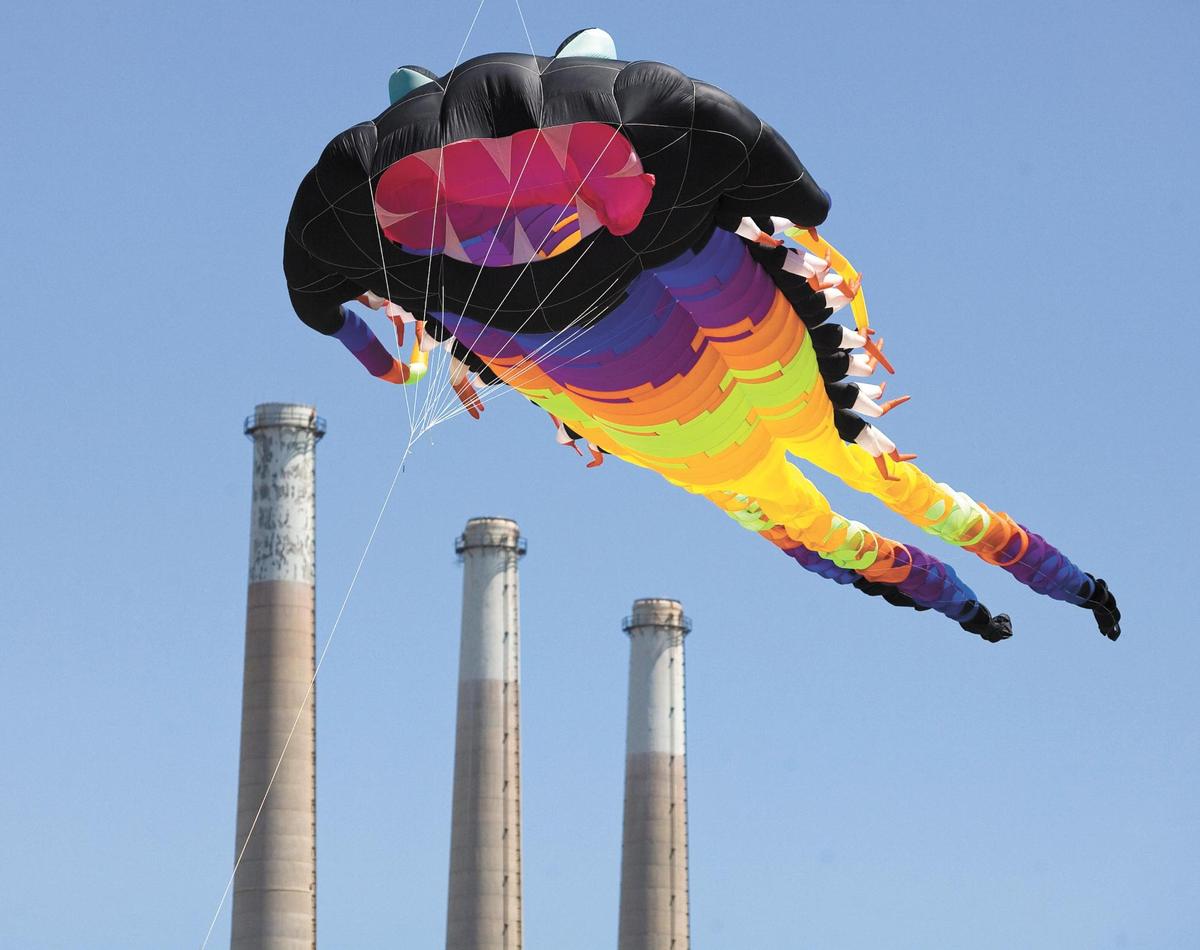 A flying hammerhead shark appears ready to devour the 450-foot-tall Morro Bay Power Plant smoke stacks during the Morro Bay Kite Festival in 2014. The festival returns to the beach north of Morro Rock in April 2022.