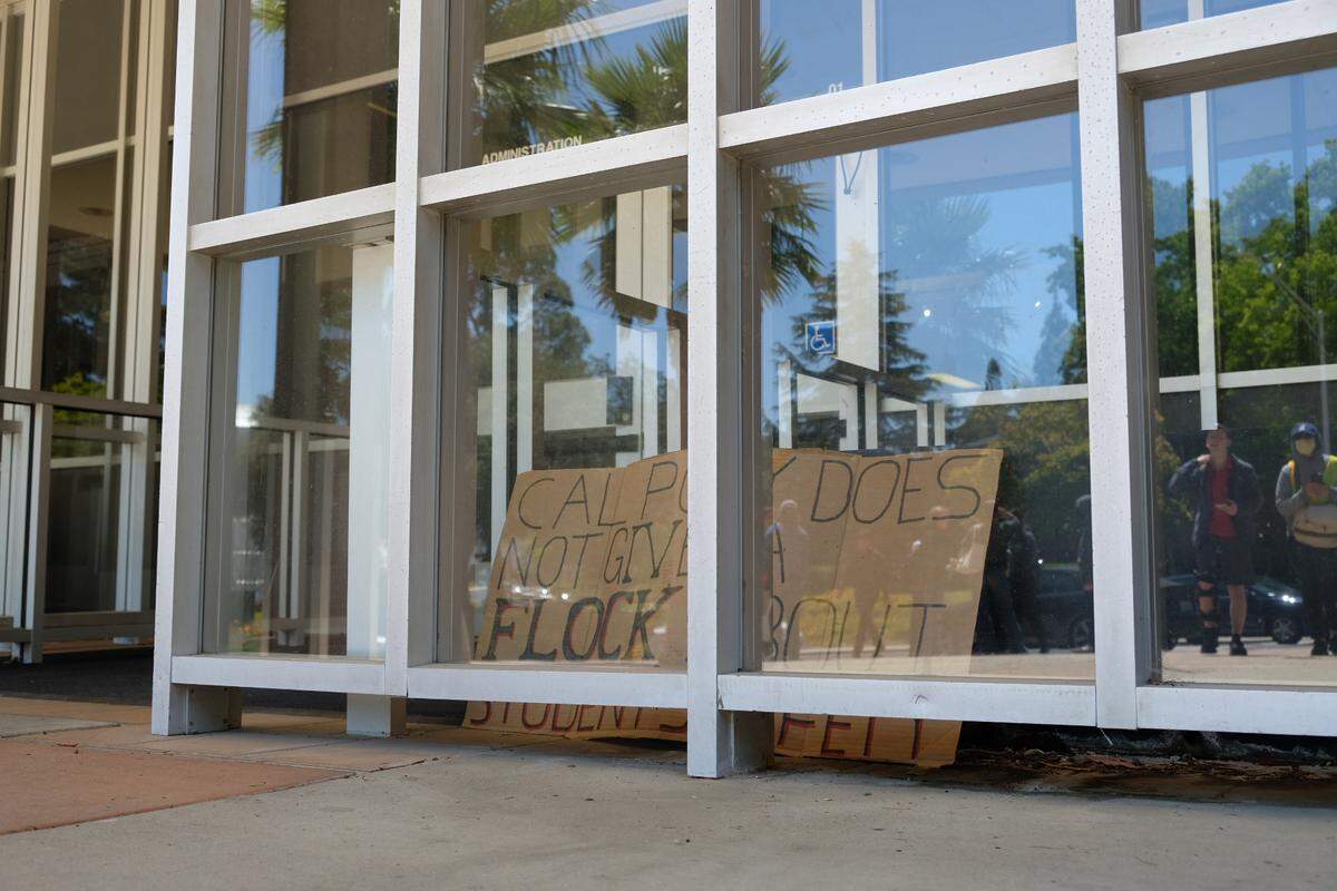 Students protested the use of Flock cameras, citing concerns about safety and privacy at Cal Poly on May 15, 2026. A sign was left at the administration building, seen here.