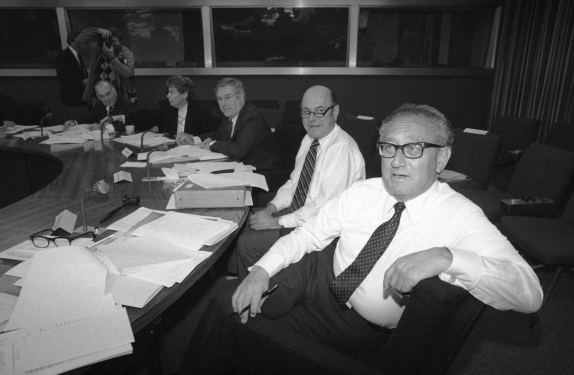 Former Secretary of State Henry Kissinger, right, chairman of President Reagans Bipartisan Commission on Central America, and its executive director, Harry W. Shlaudeman, preside over a meeting of the commission at the State Department in Washington, Friday, Jan. 6, 1983. The group is slated to make a final report to the President next Wednesday. (AP Photo/Barry Thumma)