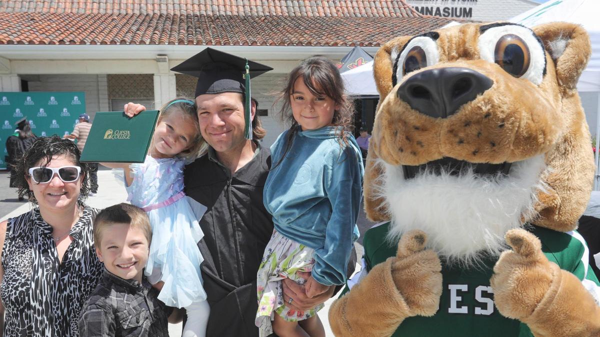 From the left Ileen Chenoth stands with her husband Brodie Chenoth as he graduates with a business administration diploma. He is holding daughter Ivy with the diploma and son Raiden. Their niece Jada is next to the mascot Cougie. Cuesta College celebrated its 60th Commencement Ceremony on campus May 23, 2025.