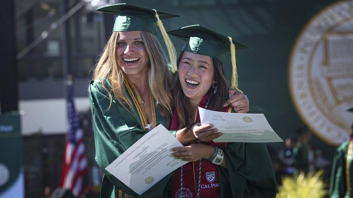 Annika Carlson, left, and Sylvia He hug after having their names called. Cal Poly held the first of six graduation ceremonies at Spanos Stadium on June 13, 2026. The College of Agriculture, Food and Environmental Science held the first ceremony.