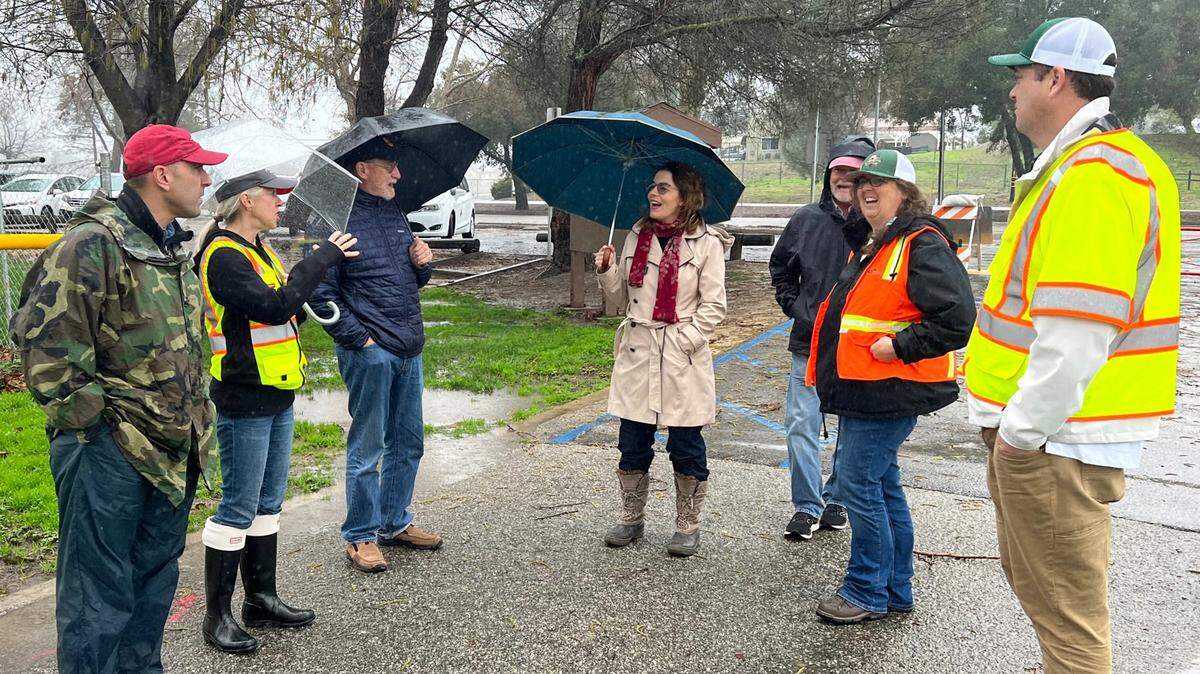Participants in a tour of storm-damaged areas of San Luis Obispo County on Saturday, Dec. 14, 2023, include, from left, U.S. Rep. Jimmy Panetta, Atascadero Mayor Heather Moreno, state Sen. John Laird, California Assemblywoman Dawn Addis, San Luis Obispo County Supervisor Bruce Gibson, Atascadero City Manager Rachelle Rickard and Ryan Betz, Atascadero Public Works management analyst. The tour, which followed a briefing held earlier in the day in Paso Robles, included this stop at Paloma Creek Park in Atascadero, one of the many areas impacted by recent storms .