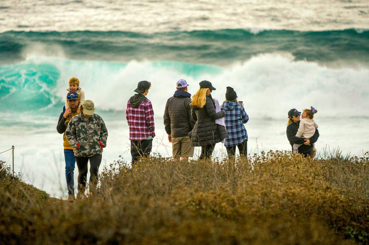 Onlookers watch waves crash off the coast of Montana de Oro State Park near Los Osos in 2021. San Luis Obispo County saw $2.3 billion in total travel spending in 2023, according to a new report.