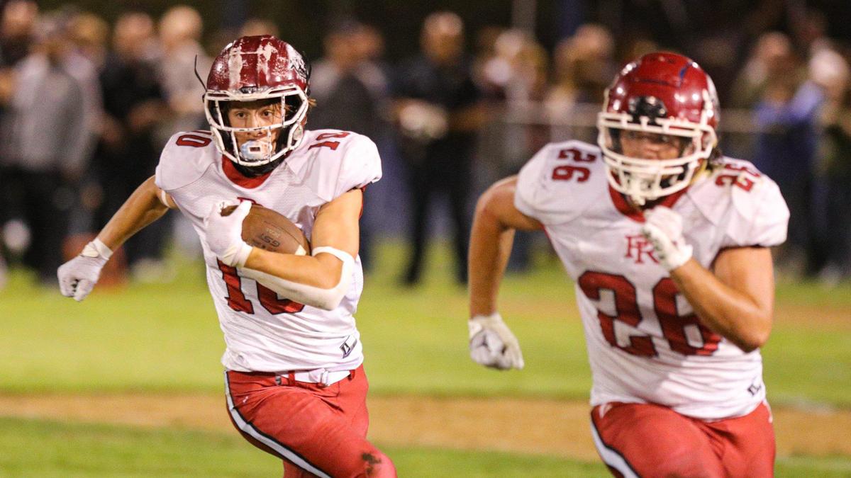 Connor Bowman runs behind Leo Kemp. Mission Prep defeated Paso Robles 28-7 in a football game on Sept. 30, 2022, in San Luis Obispo.