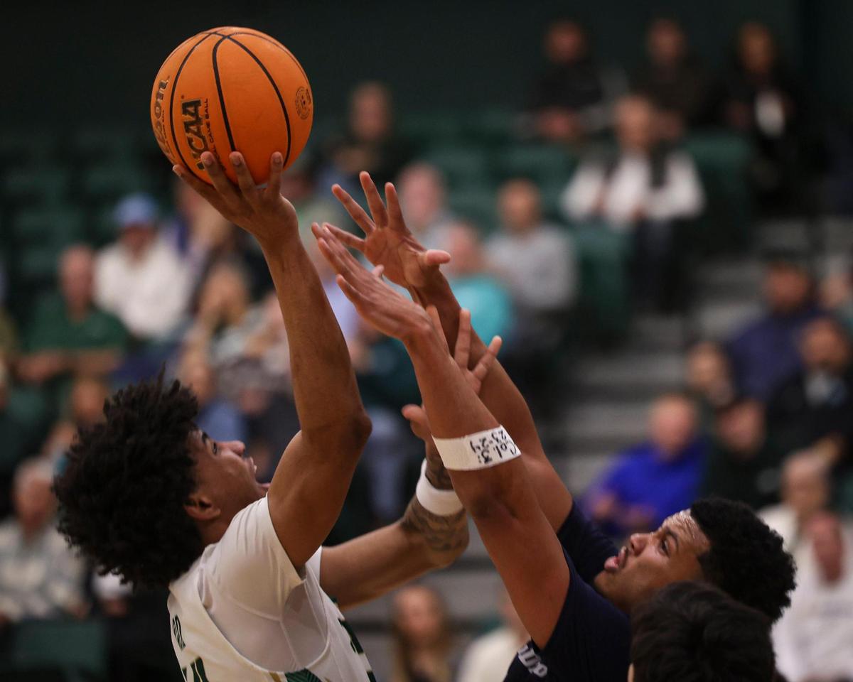 Cayden Ward takes a shot Chris Howell defends. Cal Poly lost to UCSD 81-67 in a basketball game on Feb. 20, 2025.