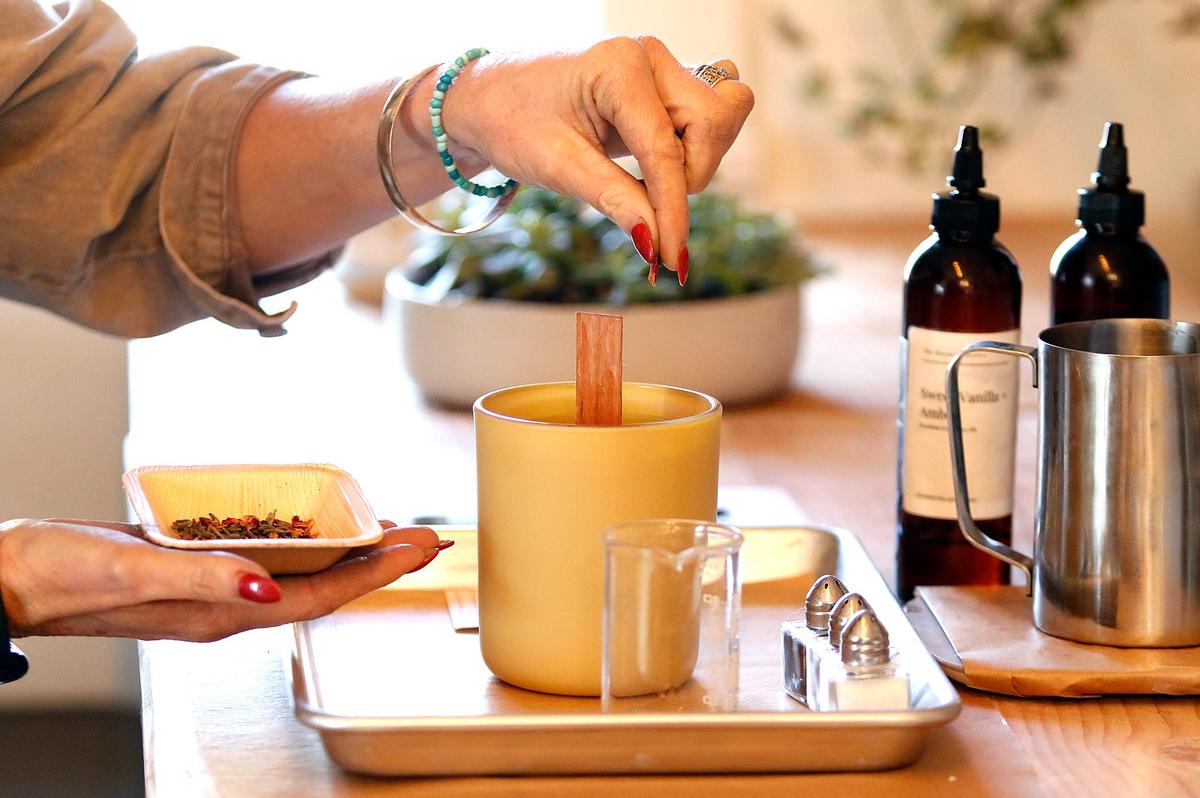 Putting the finishing touches on a freshly made candle. Candle Bar by The Mayan Collective opened at 1140 Price St. in Pismo Beach in 2022. Customers can make their own candles over a 45 minute appointment with a unique combination of scented oils and waxes with a tutorial.