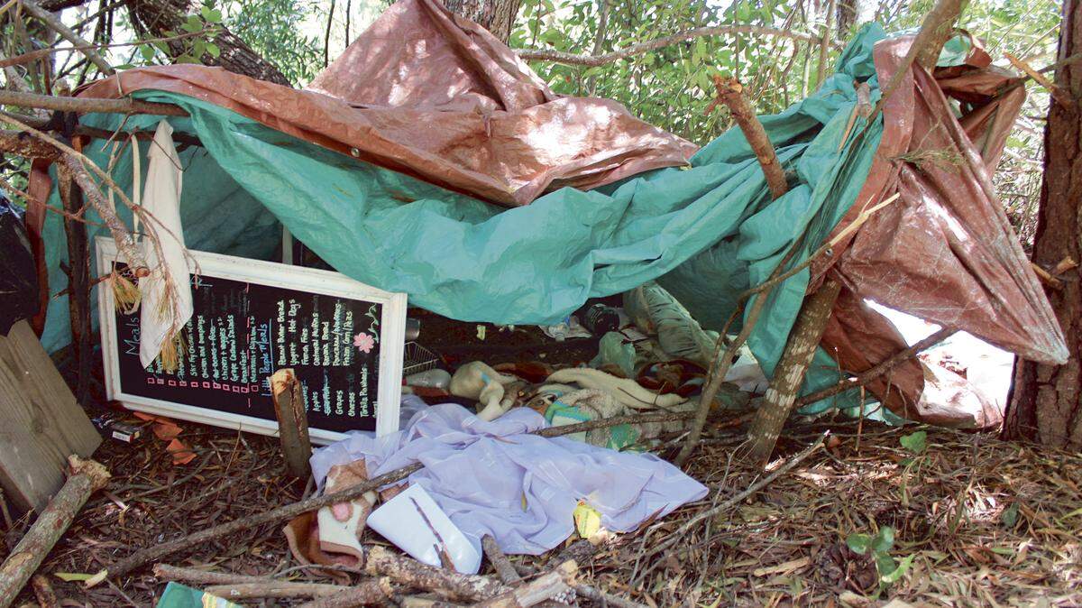 A canvas, blanket, menu signboard and other belongings in a canyon down the hill from Trenton Avenue, just east of Highway 1 — near the site of a recent fire — Saturday, June 20.