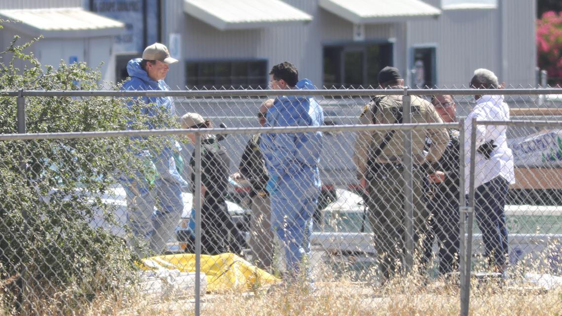 Investigators examine the scene of a homicide that was discovered Wednesday in Paso Robles after a gunman attacked the police station and shot a sheriff’s deputy. The Sheriff’s Office said a man was found shot in the head at close range near tracks north of the train station.