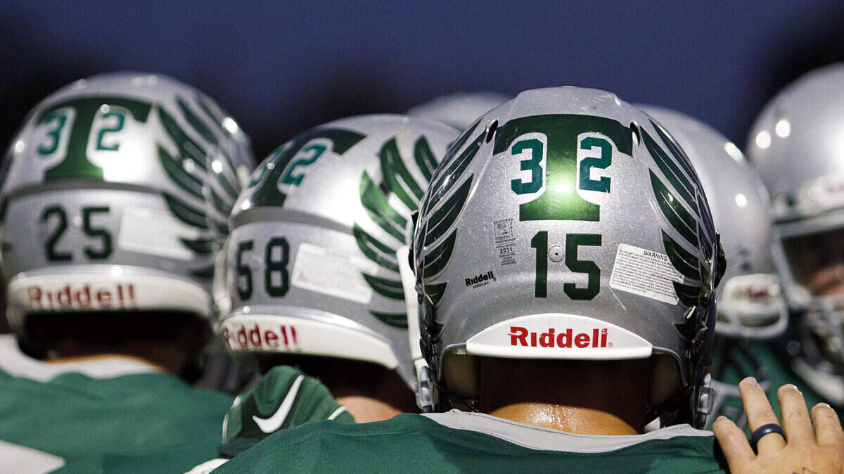 Templeton High School football players wear Isaac Lindsey's number, 32, on their helmets during their game against Cabrillo on Friday, Sept. 25, 2015.