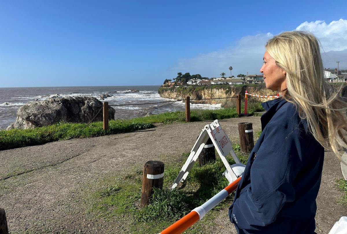 Susan Jolly gazes at the bench at Margo Dodd Park in Shell Beach that is falling off the cliff on Jan 10, 2023.