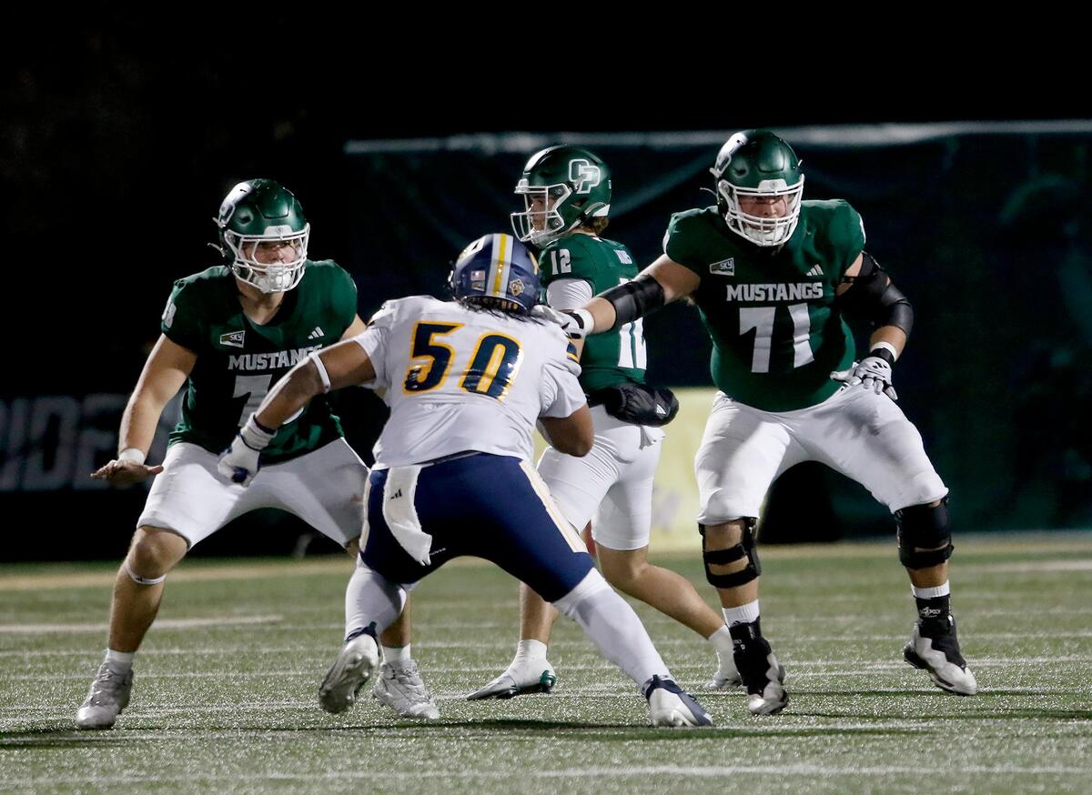 LumberJack Micah Carreon attempts to tackle Cal Poly quarterback Jackson Akins, while he’s guarded by Racin Delgatty and Charles Lincoln. Cal Poly lost to Northern Arizona 31–14 in a college football game at Mustang Memorial Field on Nov. 9, 2024.