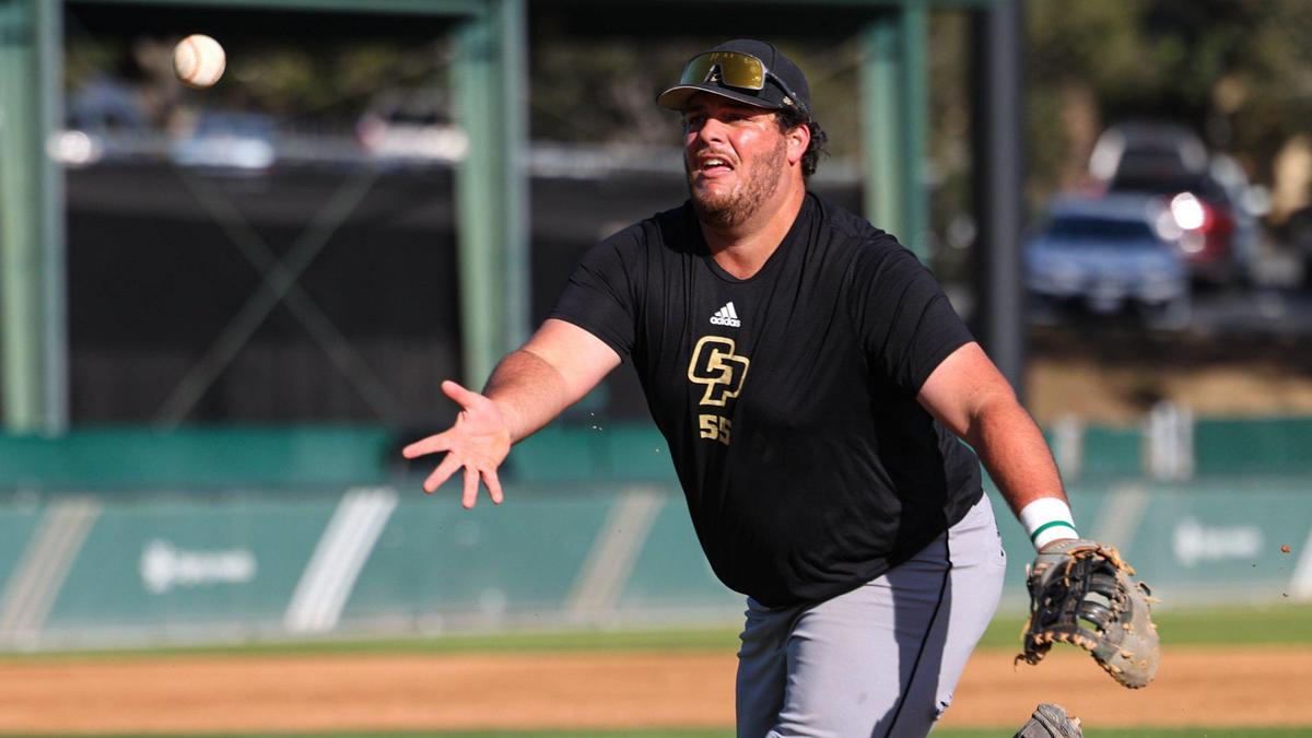 Joe Yorke tosses to the pitcher covering at first during a fielding drill as the Cal Poly baseball team practices on Feb. 14, 2023, before opening the baseball season against Missouri State.