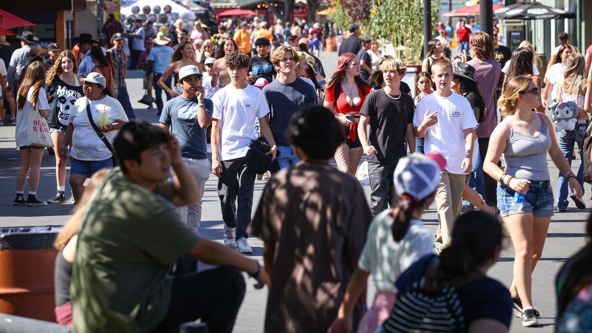 Crowds fill the midway behind the main grandstand on the first day of the California Mid-State Fair, Wednesday, July 19, 2023, in Paso Robles.