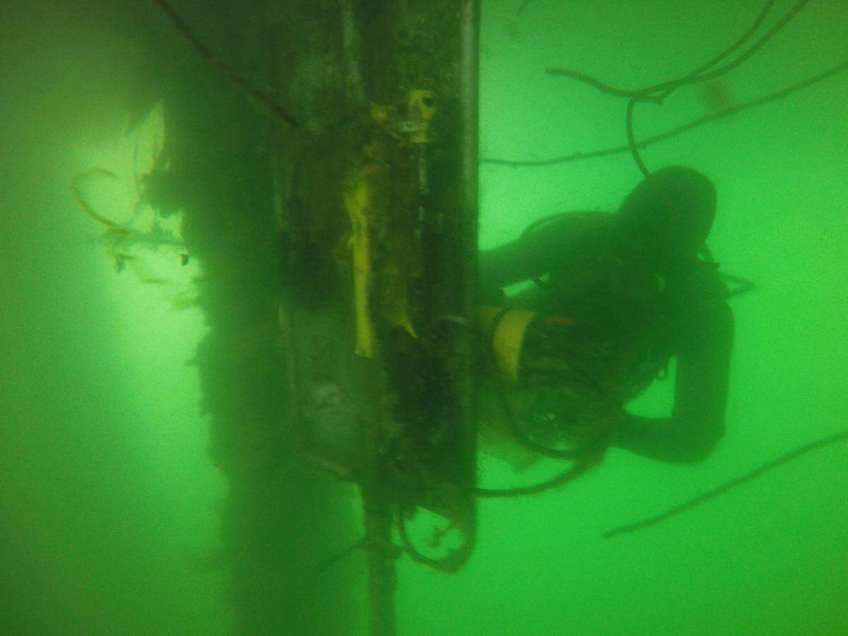 Cal Poly associate professor Ryan Walter inspects underwater sensors that monitor temperature, salinity and pH inside the Morro Bay Estuary.