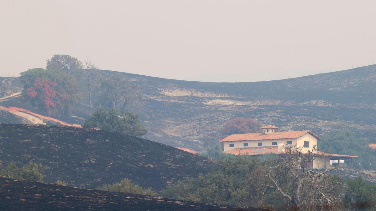 This structure survived the fast-moving fire, streaks of retardant are on the nearby hill. Bullzozers, hand crews and aerial drops were part of the defense. The Madre Fire burned on the northern side of Highway 166 and into the mountain areas toward the Carrizo Plain seen here on the second day July 3, 2025.