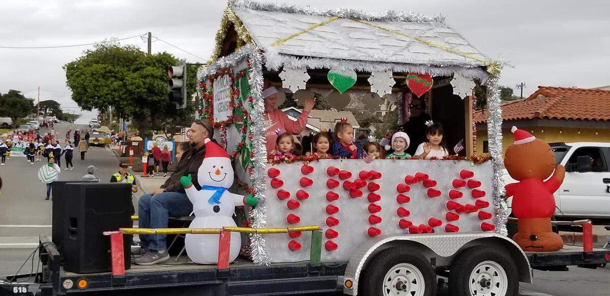 Kids with the YMCA South County program ride in the South County Holiday Parade in a festive float. Their entry won the award for Best Musical Entry.