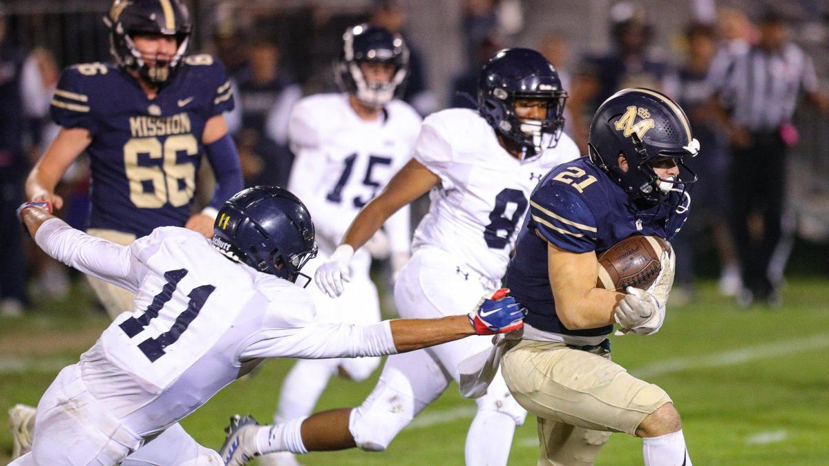 Drew Harrigan eludes Damian Santos. Mission Prep beat Arroyo Grande 41-35 in a Mountain League football game on Oct. 14, 2022.