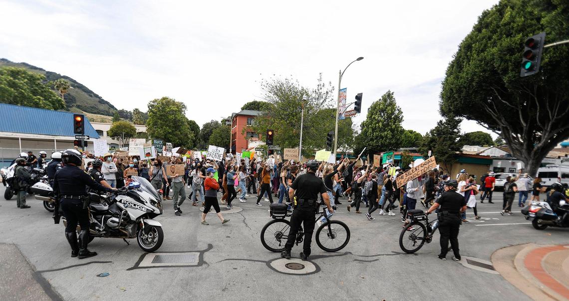 San Luis Obispo police officers on motorcycles and bicycles watch the Black Lives Matter marchers travel up Marsh Street in San Luis Obispo on Sunday, May 31, 2020.