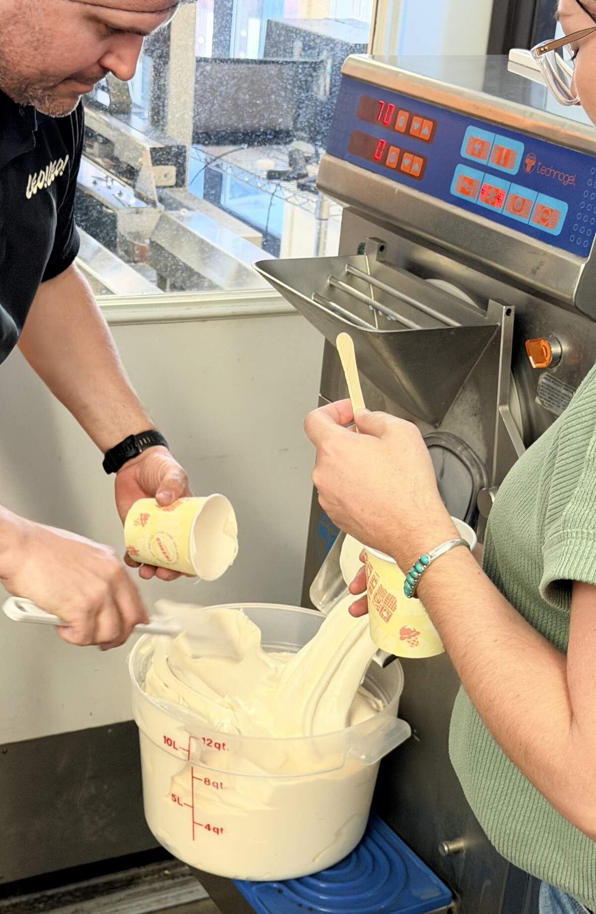 Niccolo Lekai scoops freshly made vanilla gelato into pints as it flows out of a fast-freeze machine at Leo Leo Gelato in Paso Robles during Open Farm Days Weekend on June 20, 2026.