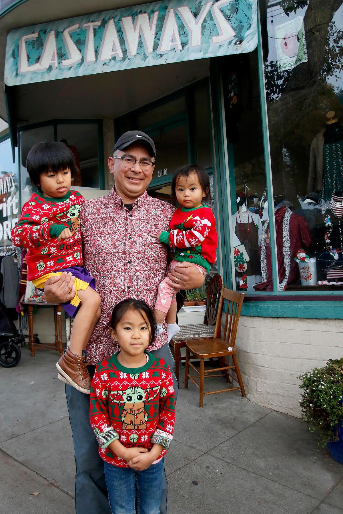 Castaways 1 owner Roman Salvador poses for a picture with his children: Santino, 4, Stella, 5, and Sia, 1. The thrift store is moving to a new location in Morro Bay.