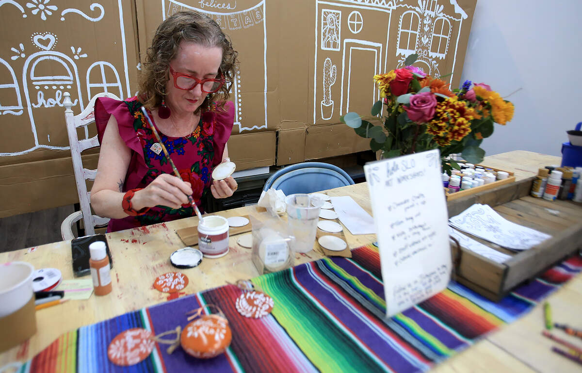 Sara McGrath paints ornaments at Hola SLO, a boutique selling Mexican-inspired gifts, jewelry, trinkets and handmade items that opened in November 2025 in downtown San Luis Obispo. The shop is a collaboration between McGrath, owner of Corazon Cafe, and Sandra Olea-Courter.