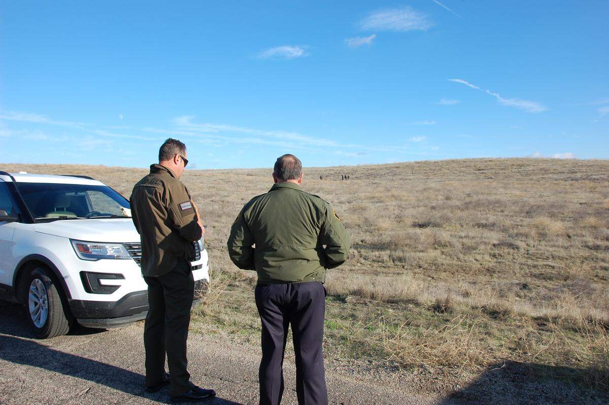 Sheriff Ian Parkinson and Chief Deputy James Taylor watch Tuesday, Dec. 18, 2018, as detectives gather evidence in an area off Highway 58 in eastern San Luis Obispo County after murder suspect Carlo Alberto Fuentes Flores led investigators to the remains of Nancy Woodrum.