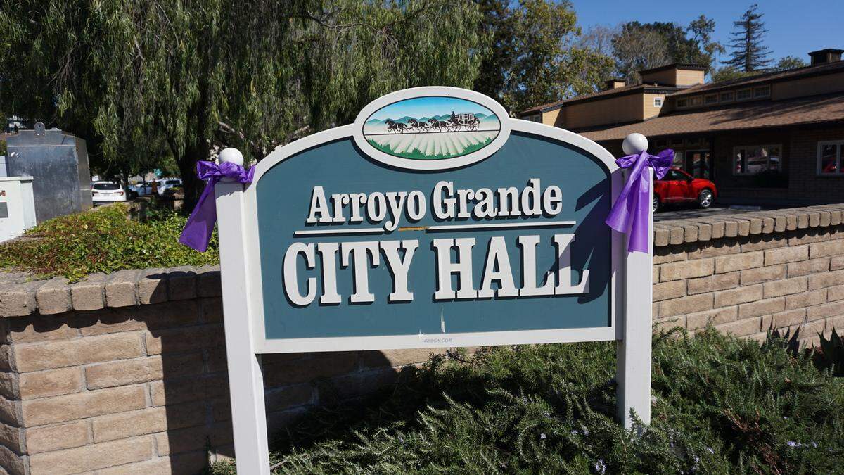 Purple ribbons are attached to posts and signs in Arroyo Grande’s Village in honor of Kristin Smart ahead of the verdict in the Paul Flores murder trial.