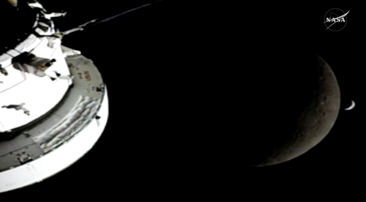 A camera on the Orion solar array capture a picture of the spacecraft, the moon and the Earth on Monday, April 6, 2026, minutes before the capsule lost communications for 40 minutes as it passed behind the moon.