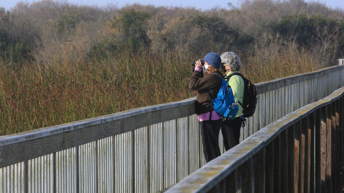 Stephanie Kolm, left, and Kathy Headtke watch birdes along the Oso Flaco Lake boardwalk. They are concerned that increased traffic and noise will impact visitors’ experience in the area. California State Parks recently released a Public Works Plan that details how the Oso Flaco Lake and other areas within the Oceano Dunes State Vehicular Recreation Area may be developed to allow better access to off-highway vehicles.