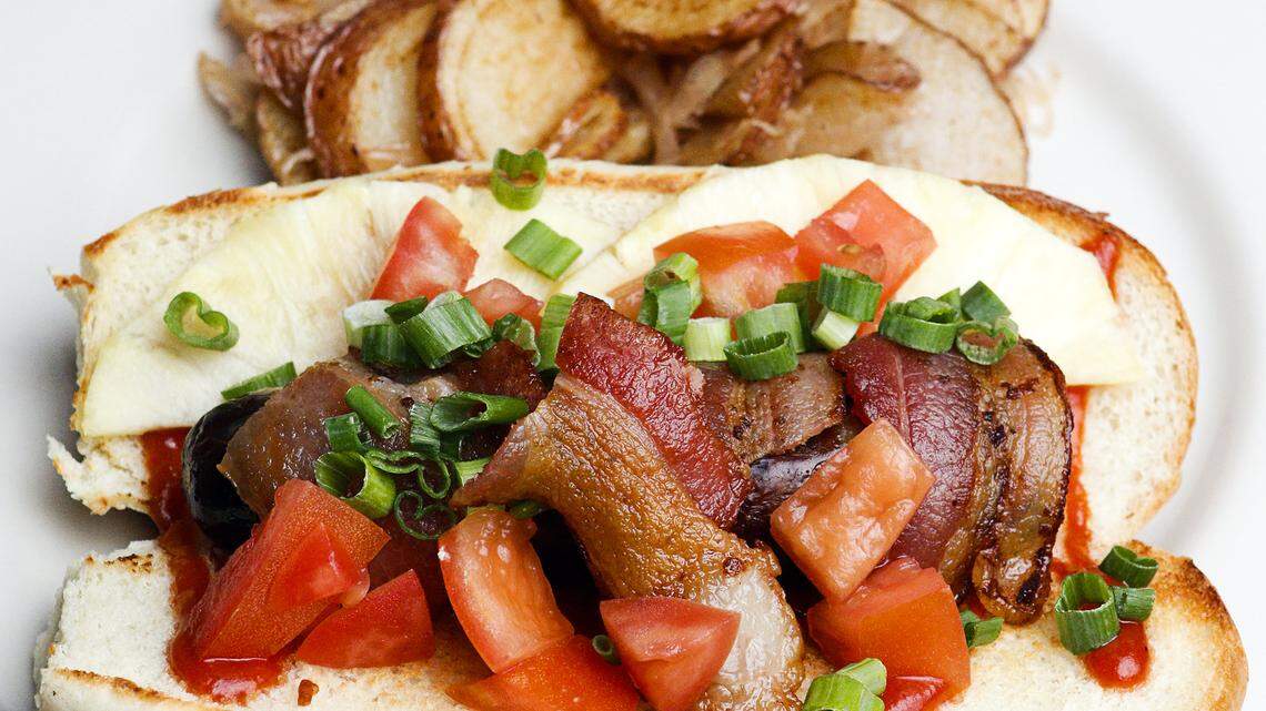 This bratwurst comes with curry ketchup, pineapple, tomato, green onion and bacon at Wineman Grillhaus in San Luis Obispo.