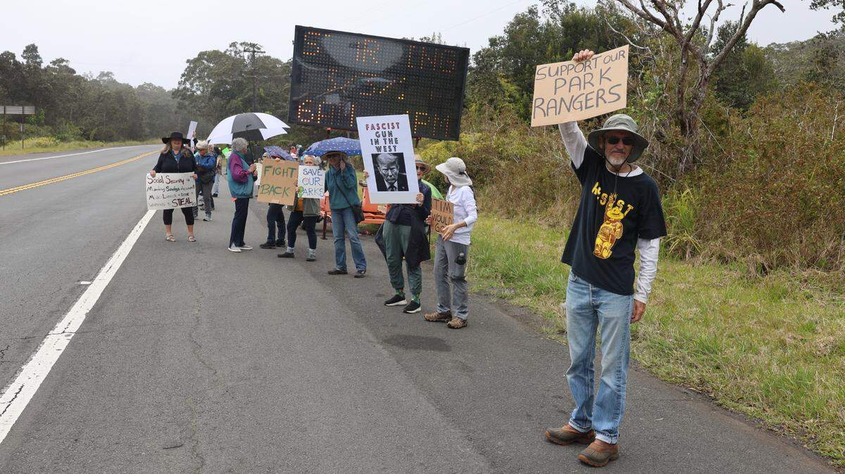 As part of a series of national protests to raise awareness about national parks staffing cuts, protesters gathered in front of Hawaii Volcanoes National Park on Saturday, March 22, 2025.