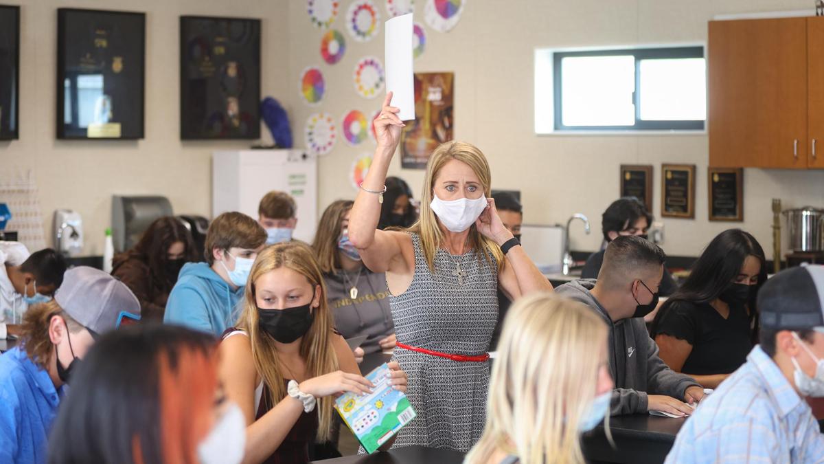 Rosemary Cummings hands out name tags to her sustainable agriculture biology class at Nipomo High School. The Lucia Mar district lost 105 employees at the end of last year.