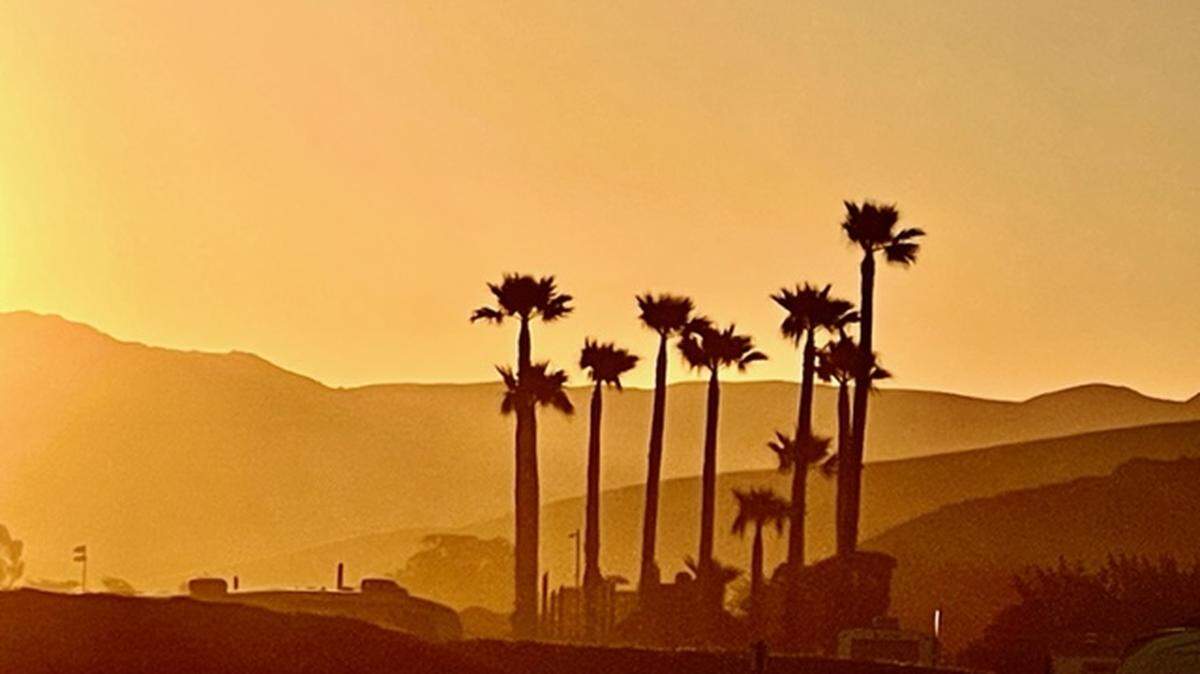 The sunrise casts a golden glow across Morro Bay in May 2022.
