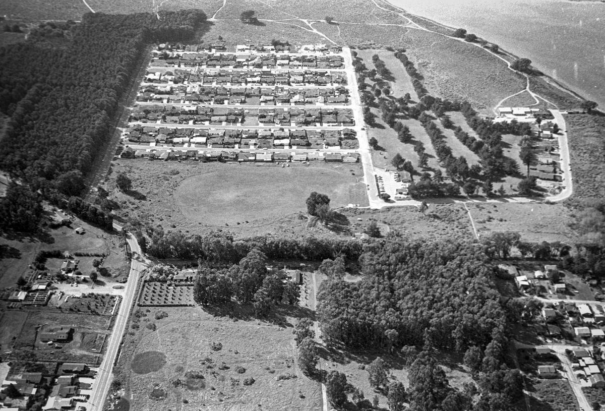 Aerial of Los Osos with Sea Pines Golf Resort at upper left, driving range in center. This was before Monarch Grove Elementary School was built. Reporter Brooks Townes took a flight over coastal areas from Morro Bay to Avila Beach on Feb. 22, 1984.