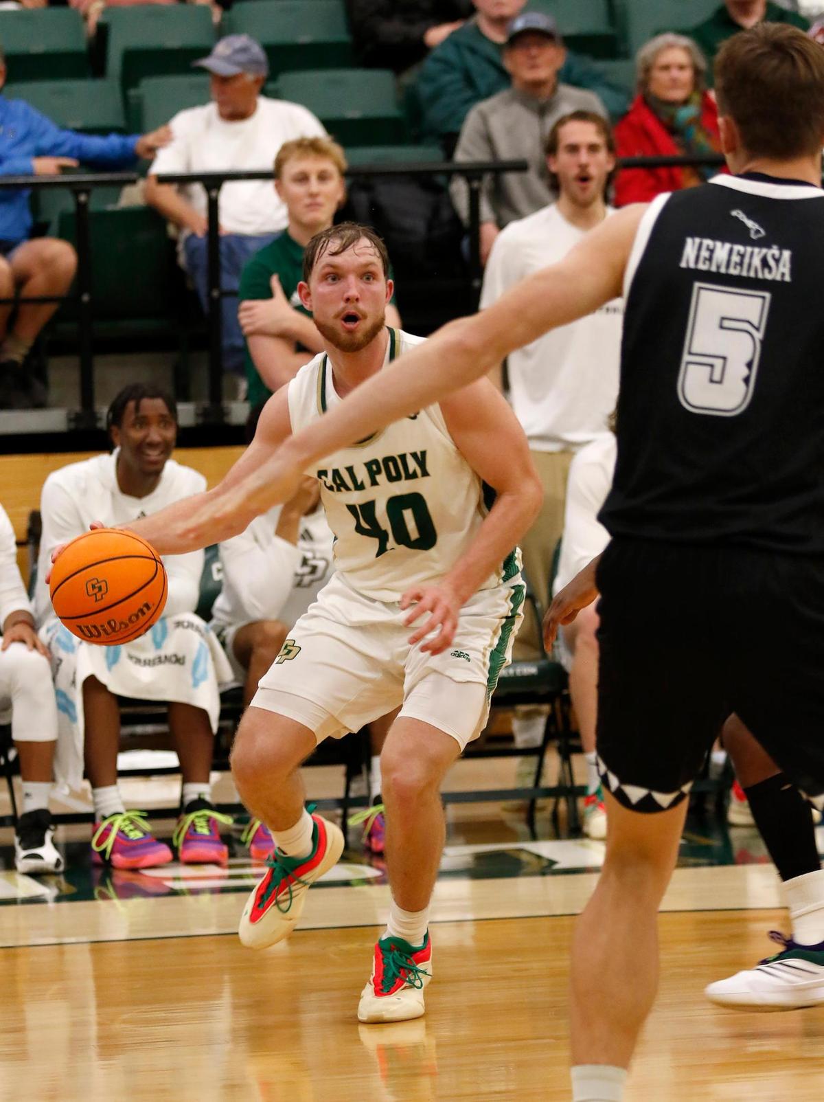 Isaac Jessup attempts to pass the ball past Gytis Nemeiksa. Cal Poly beat Hawaii 79-63 in a men’s basketball game at Mott Athletic Center in San Luis Obispo on Thursday, Feb. 6, 2025.
