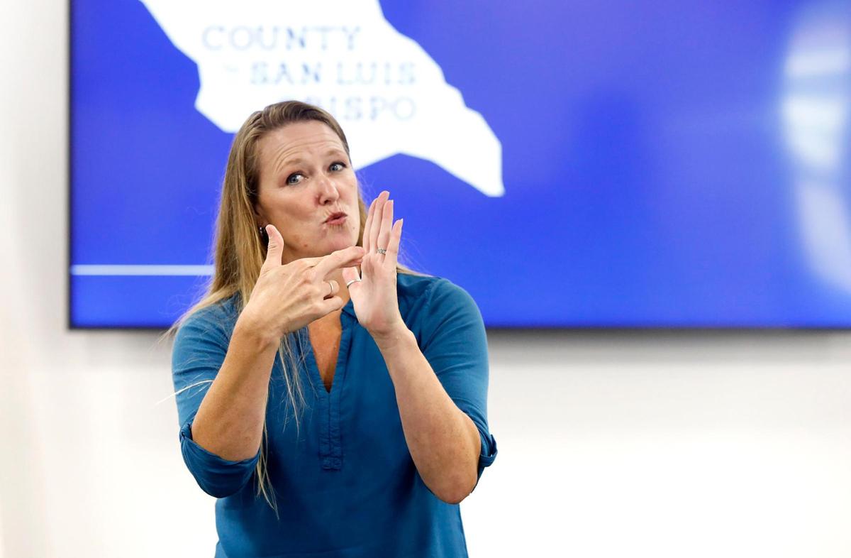 Robin Babb, a sign language interpreter, signs during a SLO County Public Health Department news conference on coronavirus.