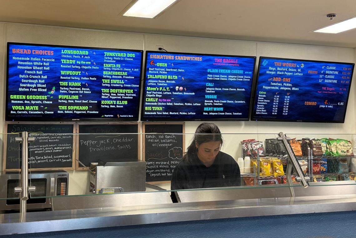A Kona’s Deli employee makes a sandwich for a customer on July 20, 2025.