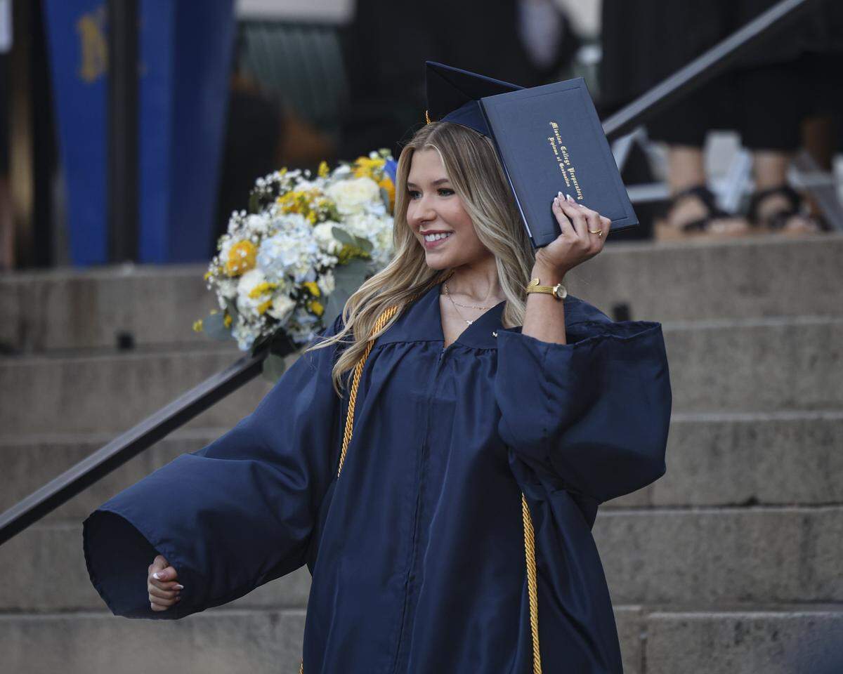 Londyn Scott waves to crowd with her diploma. Mission Prep graduated 66 students in a ceremony at Old Mission San Luis Obispo on May 29, 2026.