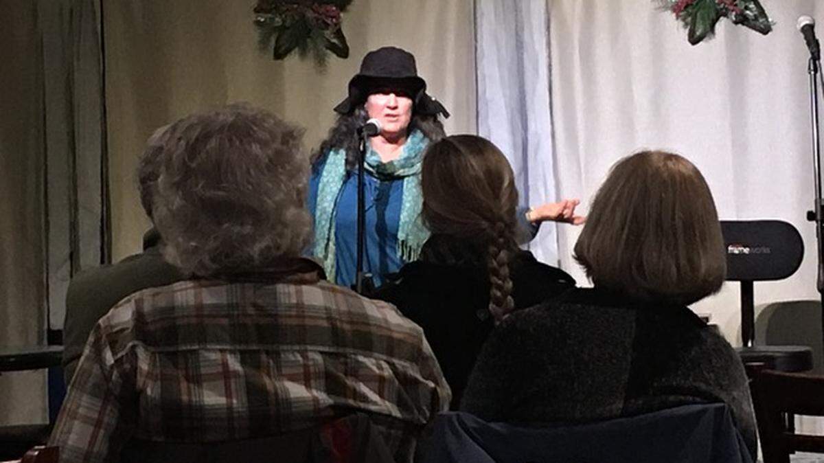 Michele Pike becomes an animated storyteller at “Moonstone Memoirs” at Moonstone Cellars lounge on a December evening.
