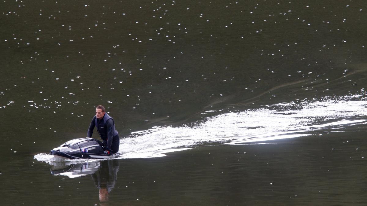 Brian Gust brings his watercraft into the dock as rain falls Saturday at Lopez Lake.