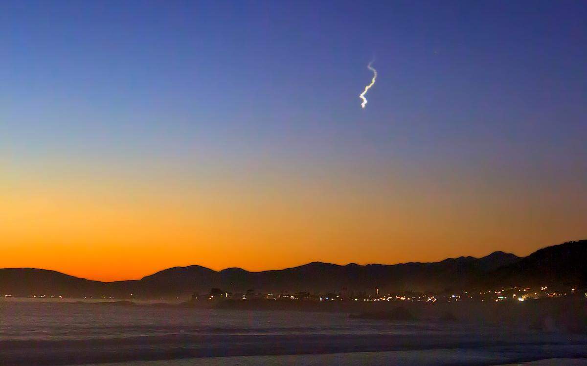 An object believed to be a meteor left a curling smoke trail in the sky at about 5:40 p.m. on Wednesday, as seen in this view from Pismo Beach.