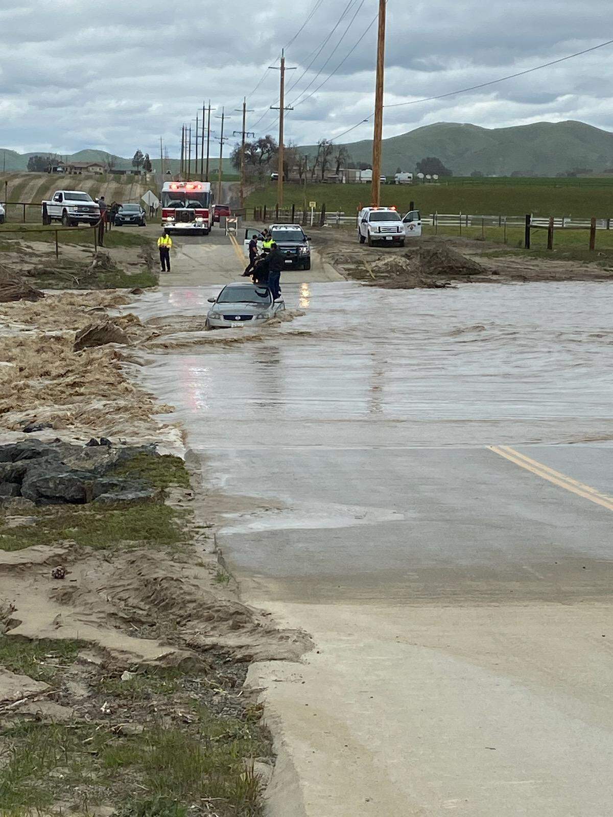 Four people were stranded on the roof of a car in Paso Robles after attempting a low water crossing on Sunday, Feb. 26, 2023.